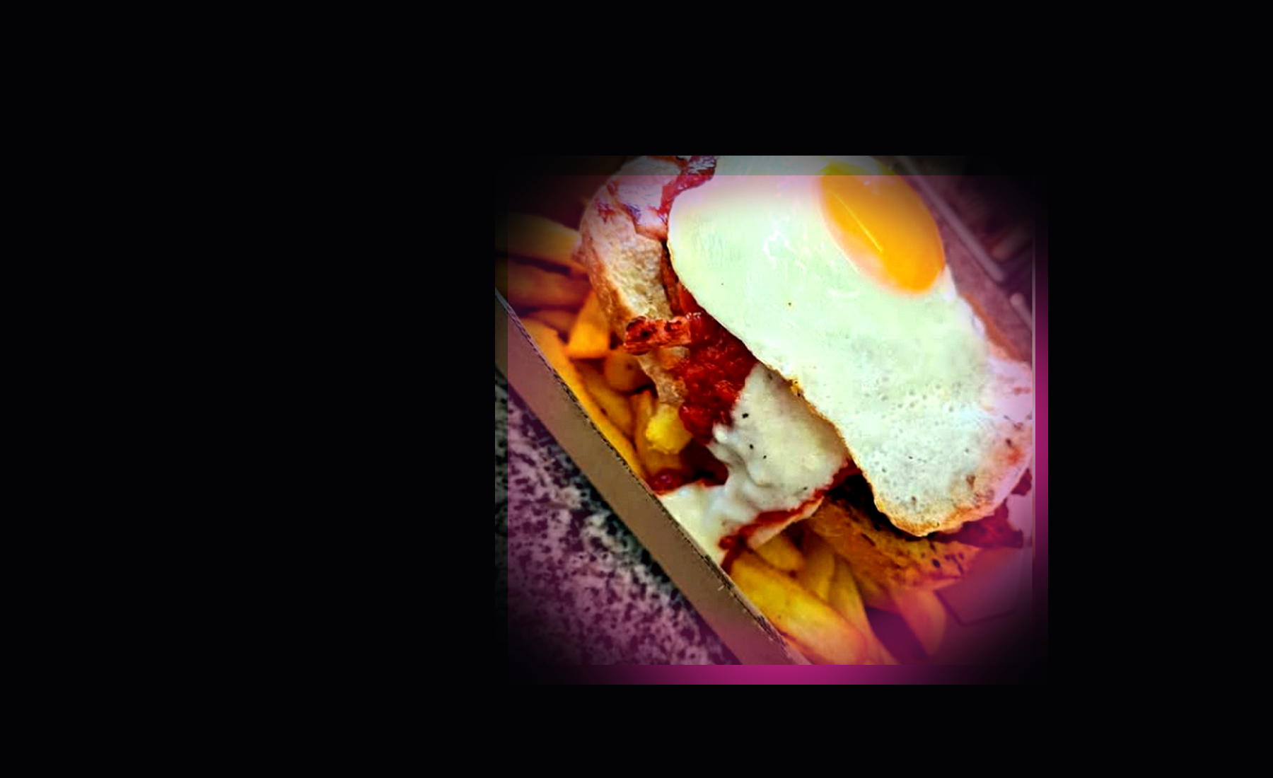 A loaded chicken parmy with melted cheese, sauce, egg and chips